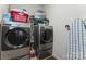 Functional laundry room equipped with modern washer and dryer units and ample storage space at 341 Pleasant Hill Se Dr, Concord, NC 28025