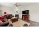 Cozy living room featuring a fireplace, ceiling fan, and open-concept design for seamless living at 341 Pleasant Hill Se Dr, Concord, NC 28025