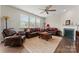 Inviting living room with plush leather seating, a ceiling fan, and a cozy fireplace at 341 Pleasant Hill Se Dr, Concord, NC 28025