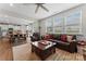 Spacious living room with leather furniture, natural light, and open view to the kitchen at 341 Pleasant Hill Se Dr, Concord, NC 28025