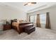 Spacious main bedroom with tray ceiling, a ceiling fan, plush carpet, and lots of natural light at 341 Pleasant Hill Se Dr, Concord, NC 28025