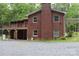 Two story brick home featuring a large deck, multiple windows offering great natural light, and back yard with gravel cover at 347 Poole Rd, Troy, NC 27371