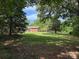 A spacious backyard features mature shade trees and a brick home at 370 Sherrill Farm Rd, Lincolnton, NC 28092