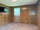 A bright bedroom features carpeted floors and classic wood paneling at 370 Sherrill Farm Rd, Lincolnton, NC 28092