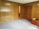 A bright bedroom features carpeted floors and classic wood paneling at 370 Sherrill Farm Rd, Lincolnton, NC 28092
