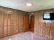Bedroom featuring an attached closet and wood paneled walls at 370 Sherrill Farm Rd, Lincolnton, NC 28092