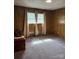 A bright bedroom features carpeted floors and classic wood paneling at 370 Sherrill Farm Rd, Lincolnton, NC 28092