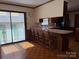 Well-lit dining area with wood floors, a bar with seating, and glass doors offering backyard views at 370 Sherrill Farm Rd, Lincolnton, NC 28092