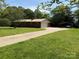 Charming brick home features a long driveway and a spacious, well-manicured front yard at 370 Sherrill Farm Rd, Lincolnton, NC 28092