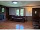 Inviting living room featuring a brick fireplace, wood paneled walls, and hardwood floors at 370 Sherrill Farm Rd, Lincolnton, NC 28092