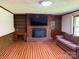 Cozy living room featuring a brick fireplace, built-in bookshelves, and a comfortable sofa at 370 Sherrill Farm Rd, Lincolnton, NC 28092
