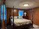 Traditional main bedroom featuring a four poster bed and wood paneled walls at 370 Sherrill Farm Rd, Lincolnton, NC 28092