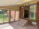 Covered patio featuring brick elements, tile flooring, and access to the interior through sliding glass doors at 370 Sherrill Farm Rd, Lincolnton, NC 28092