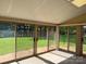 Enclosed sun room offering panoramic views of the lush green backyard, perfect for relaxation and entertainment at 370 Sherrill Farm Rd, Lincolnton, NC 28092