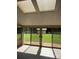 Bright sun room with skylights, tile floor, and large windows offering views of the backyard at 370 Sherrill Farm Rd, Lincolnton, NC 28092