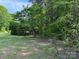 Lush, grass-covered lot with mature trees and partial clearing, providing privacy and natural beauty at 370 Sherrill Farm Rd, Lincolnton, NC 28092