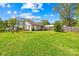 The home features a spacious grassy backyard with a partial wooden fence and mature trees for outdoor enjoyment at 406 S Gaston St, Dallas, NC 28034