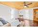 Cozy bedroom showcases a ceiling fan, hardwood floors, bright white walls, and a built-in shelving unit at 406 S Gaston St, Dallas, NC 28034