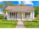 Charming home featuring a cozy front porch, well-manicured lawn, and beautiful landscaping at 406 S Gaston St, Dallas, NC 28034