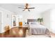 Comfortable bedroom with a ceiling fan, hardwood floors, and access to an en-suite bathroom at 406 S Gaston St, Dallas, NC 28034