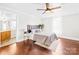 Inviting bedroom with a ceiling fan, hardwood floors, and access to a bathroom at 406 S Gaston St, Dallas, NC 28034