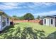 Large backyard with a well-maintained lawn, privacy fence, and storage shed at 4606 Falcon Chase Sw Dr, Concord, NC 28027