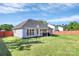 Spacious backyard featuring a well-maintained lawn, patio area, and partial privacy fence at 4606 Falcon Chase Sw Dr, Concord, NC 28027