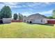 Expansive backyard with lush lawn, storage shed, and partial privacy fence at 4606 Falcon Chase Sw Dr, Concord, NC 28027
