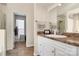 Bathroom featuring white cabinets, a sink, and a walk-in closet for extra storage at 4606 Falcon Chase Sw Dr, Concord, NC 28027