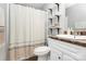Clean bathroom with a shower, vanity, modern fixtures, and convenient storage shelves at 4606 Falcon Chase Sw Dr, Concord, NC 28027