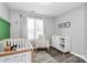 Charming Bedroom featuring a crib, rocking chair, modern decor, and soft natural lighting at 4606 Falcon Chase Sw Dr, Concord, NC 28027