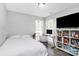Bedroom featuring a bed, desk, shelves, hardwood floors, and natural light at 4606 Falcon Chase Sw Dr, Concord, NC 28027