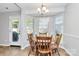 Inviting dining area with a round table, four chairs, and a bay window for natural light at 4606 Falcon Chase Sw Dr, Concord, NC 28027