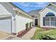 A detailed exterior featuring a well-kept lawn, fresh landscaping, and a two-car garage at 4606 Falcon Chase Sw Dr, Concord, NC 28027