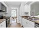 View from kitchen with tile floors to adjacent playroom, cabinets, and countertops at 4606 Falcon Chase Sw Dr, Concord, NC 28027