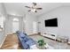 Spacious living room featuring hardwood floors, recessed lighting, and a large TV at 4606 Falcon Chase Sw Dr, Concord, NC 28027