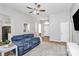 Open-concept living room featuring hardwood floors, a comfortable blue sofa, and bright, natural light at 4606 Falcon Chase Sw Dr, Concord, NC 28027
