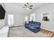 Bright living room featuring hardwood floors, a ceiling fan, and a large window for natural light at 4606 Falcon Chase Sw Dr, Concord, NC 28027