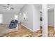 Cozy living room with a hardwood floors, plush blue sofa, and bright natural light at 4606 Falcon Chase Sw Dr, Concord, NC 28027