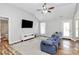 Bright living room featuring hardwood floors, vaulted ceilings, and a comfortable blue sofa at 4606 Falcon Chase Sw Dr, Concord, NC 28027