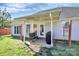 Covered outdoor patio with grill, wooden bench, direct house access, perfect for relaxation and entertainment at 4606 Falcon Chase Sw Dr, Concord, NC 28027