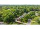Aerial view of a home surrounded by mature trees, showcasing a private backyard and driveway at 4611 Cringle Ct, Charlotte, NC 28226