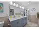 Modern bathroom featuring a double vanity with marble countertops and neutral tile flooring at 4611 Cringle Ct, Charlotte, NC 28226