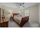 Well-lit bedroom with a large bed, wooden furniture, carpeted floors, and bright natural light at 4611 Cringle Ct, Charlotte, NC 28226