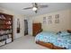 Bright bedroom with a ceiling fan, carpet flooring and a built in bookshelf at 4611 Cringle Ct, Charlotte, NC 28226