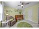 Bright Bedroom with a crib, chair, playful monkey-themed wall decals, and a round green rug at 4611 Cringle Ct, Charlotte, NC 28226