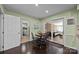 Inviting dining area with a round table, leading to a cozy sunroom with comfortable seating at 4611 Cringle Ct, Charlotte, NC 28226