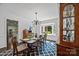 Dining room featuring a bay window offering natural light, hardwood floors, and a stylish china cabinet at 4611 Cringle Ct, Charlotte, NC 28226