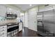 Modern kitchen featuring stainless steel appliances, granite countertops, and dark hardwood floors at 4611 Cringle Ct, Charlotte, NC 28226