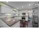 Well-lit kitchen featuring white cabinets, stainless steel appliances, granite countertops and hardwood floors at 4611 Cringle Ct, Charlotte, NC 28226
